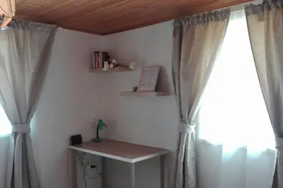 a room with curtains and a table and a window at U Pichlerů in Klipec