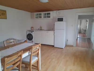 a kitchen with a table and a white refrigerator at U Pichlerů in Klipec