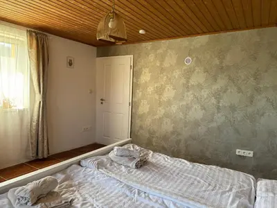 a bedroom with a bed with towels on it at U Pichlerů in Klipec