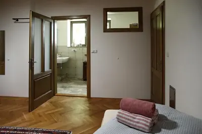 a room with a bed and a bathroom with a mirror at Ubytování na statku in Vědomice