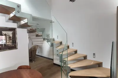 a glass staircase in a house at Kolkovna 5 Penthouse in Prague