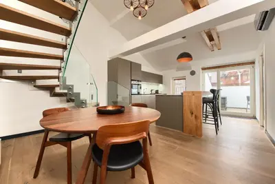 a kitchen and dining room with a wooden table and chairs at Kolkovna 5 Penthouse in Prague