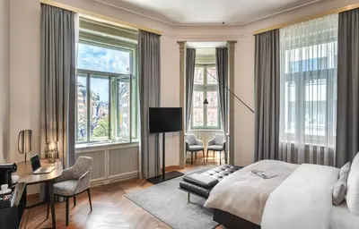 a hotel room with a bed and a desk and chairs at Mottl House by Adrez in Prague