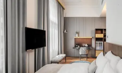 a hotel room with a bed and a television at Mottl House by Adrez in Prague