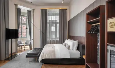 a hotel room with a bed and a television at Mottl House by Adrez in Prague