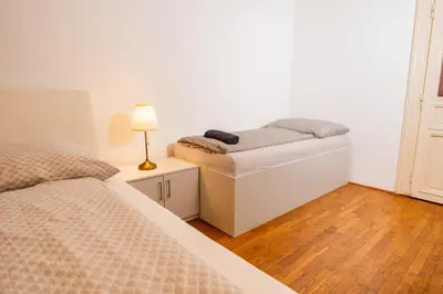 a bedroom with two beds and a lamp on a table at 6 Bob's Apartments - 3 bedrooms, King size beds in Prague