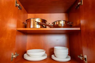 a kitchen with plates and pots and pans on shelves at 6 Bob's Apartments - 3 bedrooms, King size beds in Prague