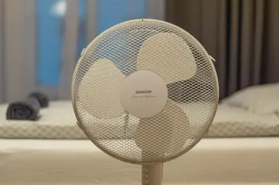a white fan sitting in front of a bed at 6 Bob's Apartments - 3 bedrooms, King size beds in Prague