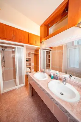 a bathroom with two sinks and a shower at 6 Bob's Apartments - 3 bedrooms, King size beds in Prague