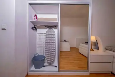 a small room with a sink and a room with a bedroom at 6 Bob's Apartments - 3 bedrooms, King size beds in Prague