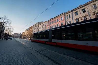 a train on a city street with buildings at 6 Bob's Apartments - 3 bedrooms, King size beds in Prague