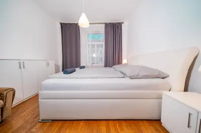 a white bed in a room with a window at 6 Bob's Apartments - 3 bedrooms, King size beds in Prague