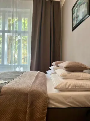 a bedroom with a bed with pillows and a window at Prague - Karlin Apartments in Prague