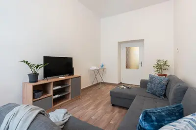 a living room with a couch and a television at Prague - Karlin Apartments in Prague