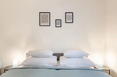 a living room with a washing machine and a kitchen at Prague - Karlin Apartments in Prague