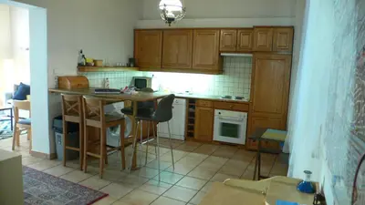 a kitchen with wooden cabinets and a table with chairs at Mala Strana apartment 1 in Prague