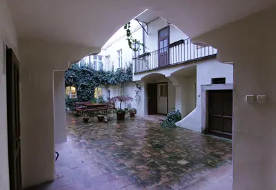 an archway in a building with a courtyard with plants at Mala Strana apartment 1 in Prague