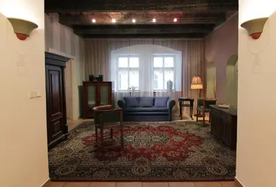 a living room with a blue couch and a window at Mala Strana apartment 1 in Prague