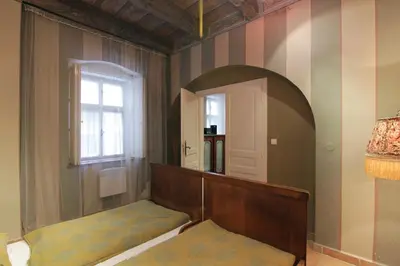 a room with a bed and a mirror and a window at Mala Strana apartment 1 in Prague