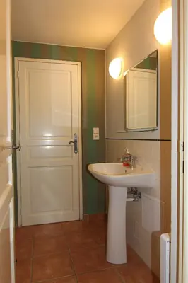 a bathroom with a sink and a mirror and a door at Mala Strana apartment 1 in Prague