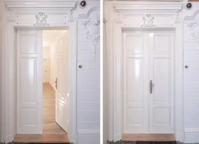 two white doors in a room with a hallway at Arch III at Wenceslas in Prague