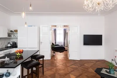 a kitchen and living room with a table and chairs at Arch III at Wenceslas in Prague