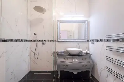 a bathroom with a sink and a mirror at Arch III at Wenceslas in Prague