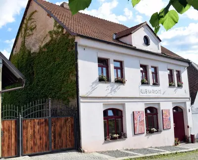 a white house with ivy on the side of it at Rychta in Rataje nad Sázavou
