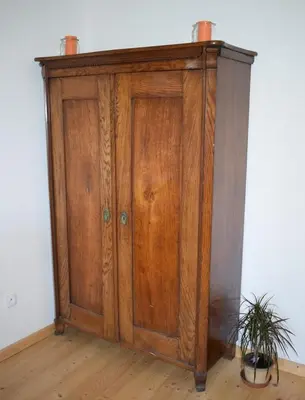 a wooden cabinet with two cups on top of it at Rychta in Rataje nad Sázavou
