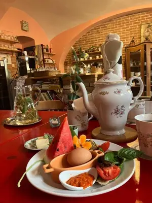 a table with a tea pot and a plate of food at Rychta in Rataje nad Sázavou