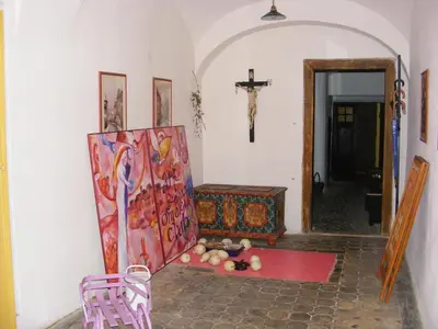 a room with a painting and a cross on the wall at Rychta in Rataje nad Sázavou