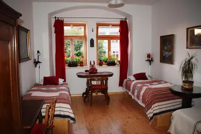 a room with two beds and a table and a window at Rychta in Rataje nad Sázavou