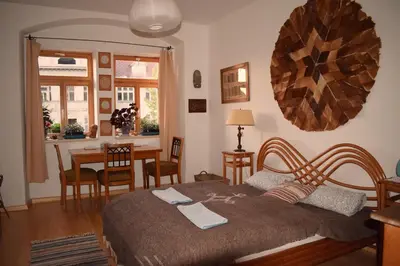 a bedroom with a bed and a table and chairs at Rychta in Rataje nad Sázavou