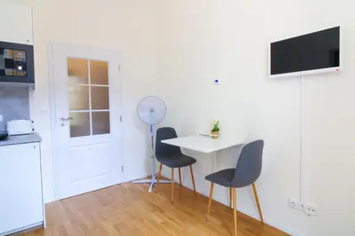 a kitchen with a table and two chairs in a room at Bouquet Apartments in Prague