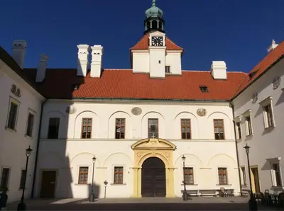 a large building with a clock tower on top of it at gemuetliche unterkunft bei prag in Smečno