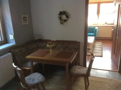 a living room with a table and a couch at gemuetliche unterkunft bei prag in Smečno