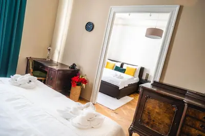 a bedroom with two beds and a mirror at Luxurious Kafka family apt in Old Town in Prague