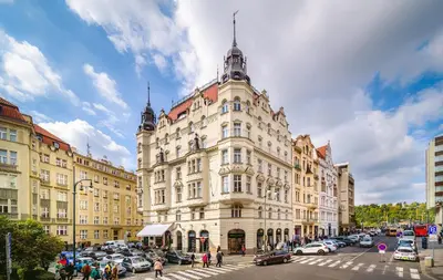a large building with cars parked in front of it at Luxurious Kafka family apt in Old Town in Prague