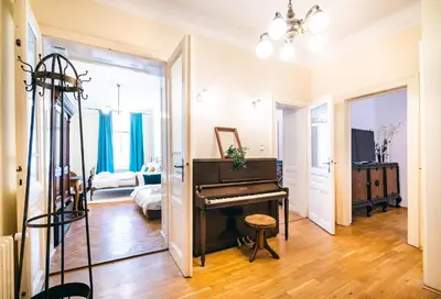 a living room with a piano and a bedroom at Luxurious Kafka family apt in Old Town in Prague
