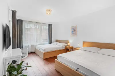 a bedroom with two beds and a flat screen tv at The Dante Prague - Family Apartments with FREE PARKING in Prague