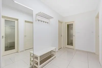 a white room with a staircase and mirrors at The Dante Prague - Family Apartments with FREE PARKING in Prague