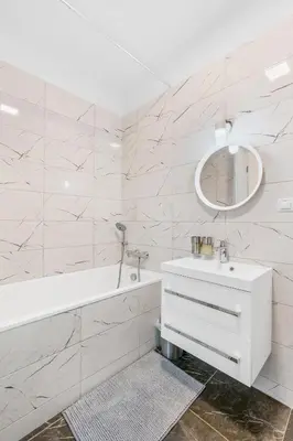 a white bathroom with a tub and a sink at The Dante Prague - Family Apartments with FREE PARKING in Prague
