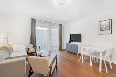 a living room with a couch and a table at The Dante Prague - Family Apartments with FREE PARKING in Prague