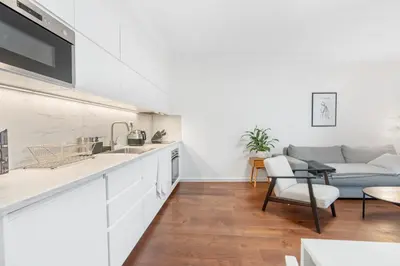 a kitchen and living room with a couch at The Dante Prague - Family Apartments with FREE PARKING in Prague