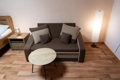 a living room with a couch and a table at Hotel U Beránků in Libochovice