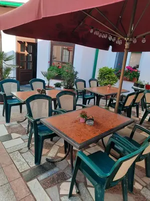 a group of tables with chairs and an umbrella at Hotel U Beránků in Libochovice
