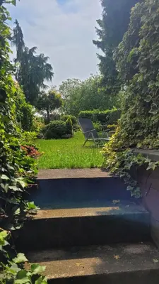a chair sitting on the grass in a garden at Apartmán Třebenice - vstupní brána do Českého středohoří in Třebenice