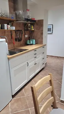 a kitchen with white cabinets and a white refrigerator at Apartmán Třebenice - vstupní brána do Českého středohoří in Třebenice