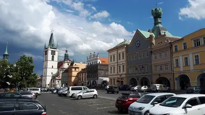 a city street with cars parked in a parking lot at Apartmán Třebenice - vstupní brána do Českého středohoří in Třebenice