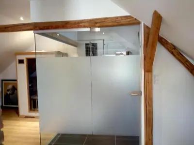 a shower with a glass door in a bathroom at Podkroví s koupelnou in Svinařov